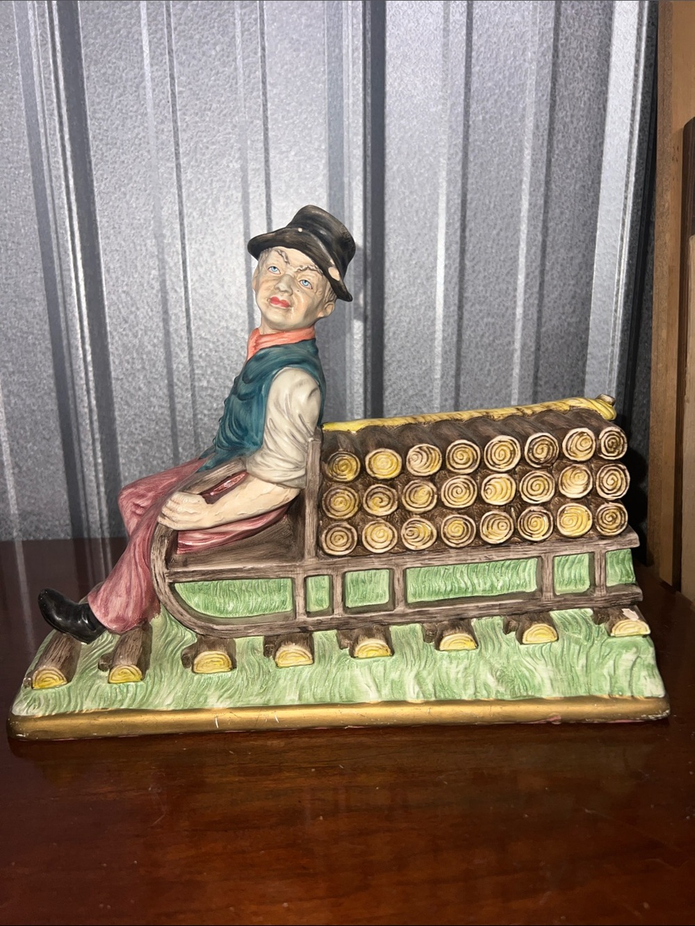 Vintage Ceramic Figurine Man on Log Sleigh